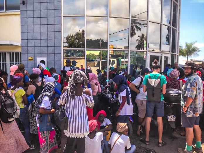 Les jeunes lycéens sont assis en nombre devant un bâtiment institutionnel